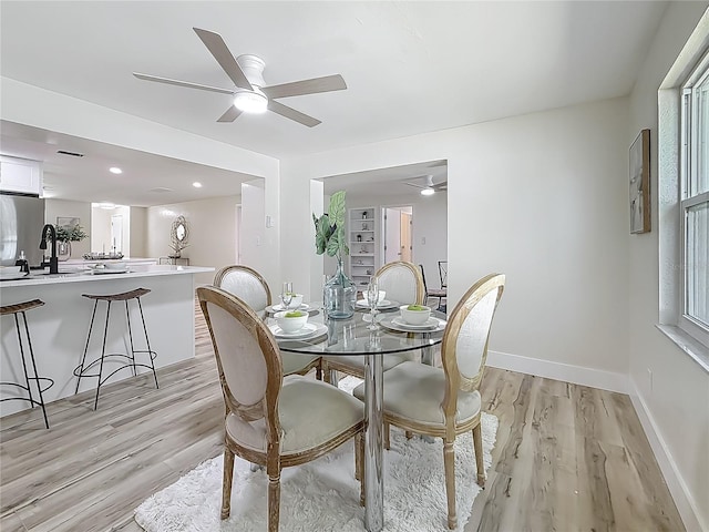 1469 S Hillcrest Ave, Clearwater, FL 33756 - dining room featuring light wood-style floors, baseboards, and ceiling fan