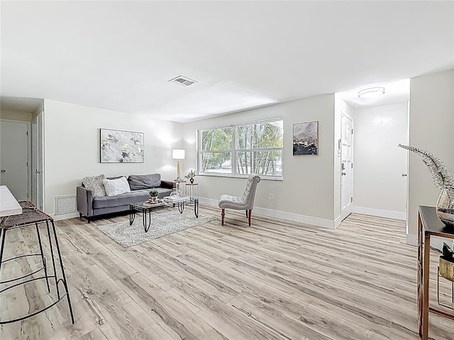1469 S Hillcrest Ave, Clearwater, FL 33756 - living room featuring light wood-type flooring and baseboards