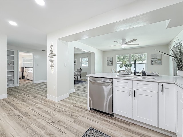 1469 S Hillcrest Ave, Clearwater, FL 33756 - kitchen featuring dishwasher, a sink, a ceiling fan, light countertops, and white cabinetry