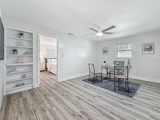 1469 S Hillcrest Ave, Clearwater, FL 33756 - office featuring wood finished floors, a ceiling fan, baseboards, and built in shelves