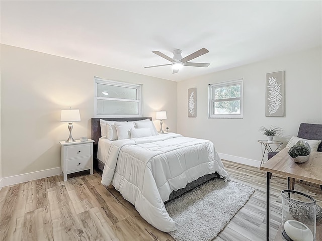 1469 S Hillcrest Ave, Clearwater, FL 33756 - bedroom with baseboards, light wood-style flooring, and a ceiling fan