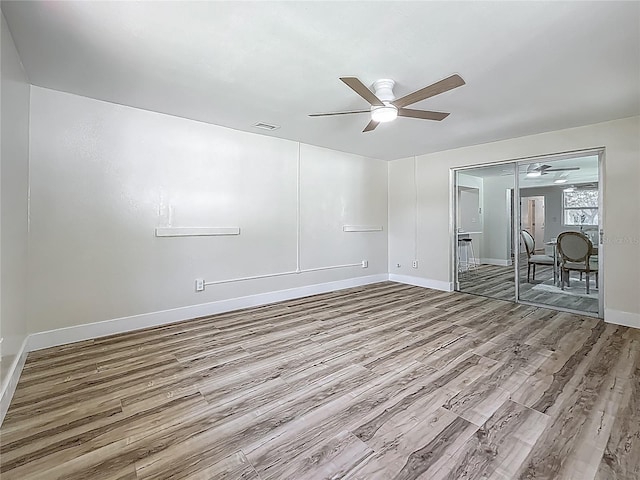1469 S Hillcrest Ave, Clearwater, FL 33756 - spare room with ceiling fan, wood finished floors, and baseboards