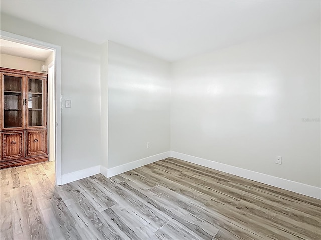 1469 S Hillcrest Ave, Clearwater, FL 33756 - empty room with light wood-style flooring and baseboards