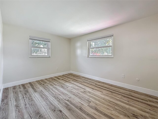 1469 S Hillcrest Ave, Clearwater, FL 33756 - unfurnished room with healthy amount of natural light, wood finished floors, and baseboards