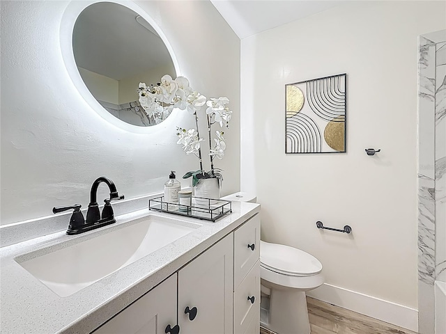 1469 S Hillcrest Ave, Clearwater, FL 33756 - bathroom with vanity, toilet, baseboards, and wood finished floors