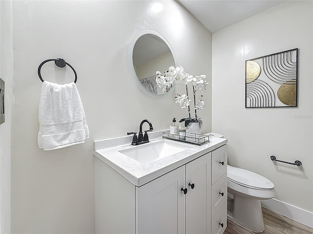 1469 S Hillcrest Ave, Clearwater, FL 33756 - bathroom featuring wood finished floors, vanity, toilet, and baseboards