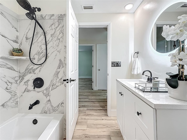 1469 S Hillcrest Ave, Clearwater, FL 33756 - bathroom featuring vanity, washtub / shower combination, and wood finished floors