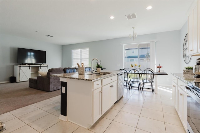 kitchen featuring a sink, light tile patterned floors, appliances with stainless steel finishes, and visible vents