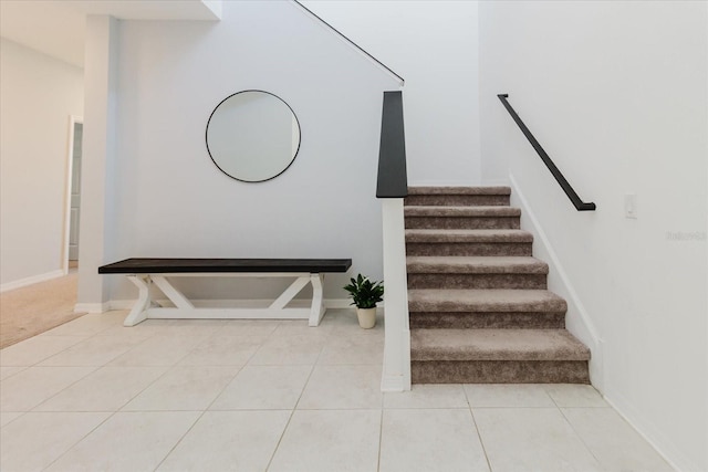 stairs with tile patterned floors and baseboards