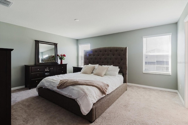 bedroom featuring visible vents, baseboards, and carpet floors