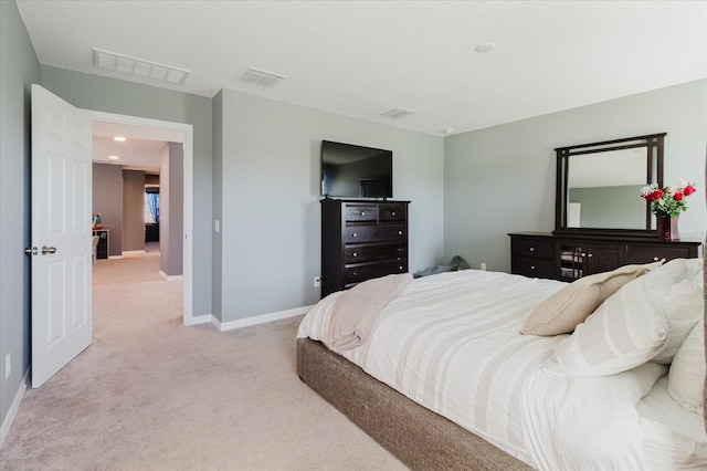bedroom with light carpet, visible vents, and baseboards