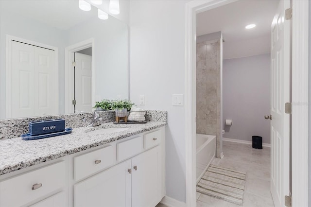 bathroom featuring vanity, baseboards, and tile patterned flooring