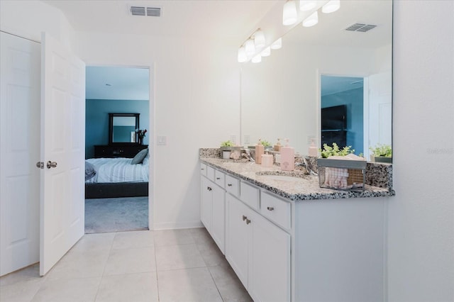 ensuite bathroom featuring a sink, visible vents, double vanity, and ensuite bath
