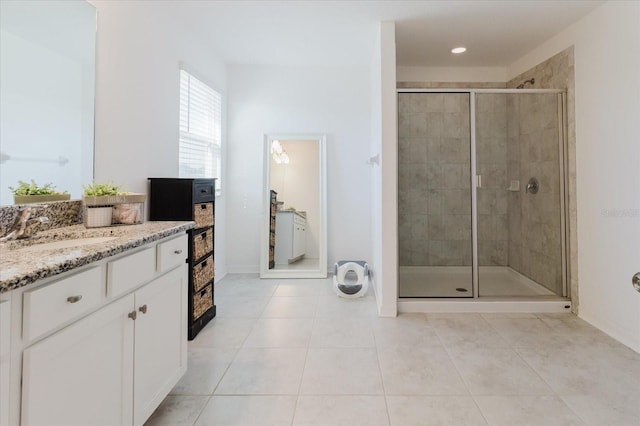 bathroom with vanity, recessed lighting, a stall shower, baseboards, and tile patterned floors
