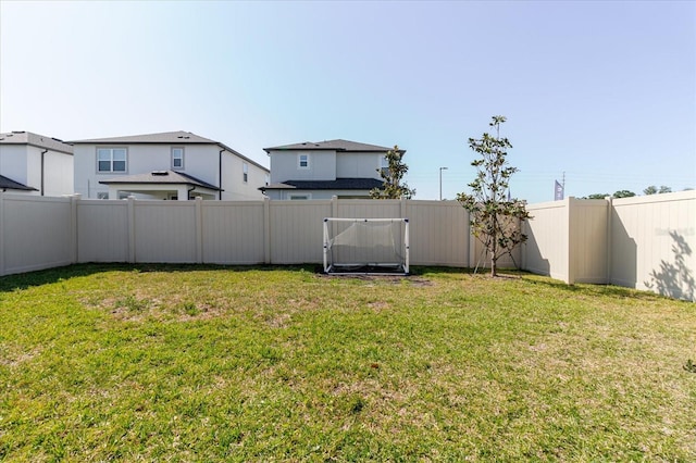 view of yard with a fenced backyard