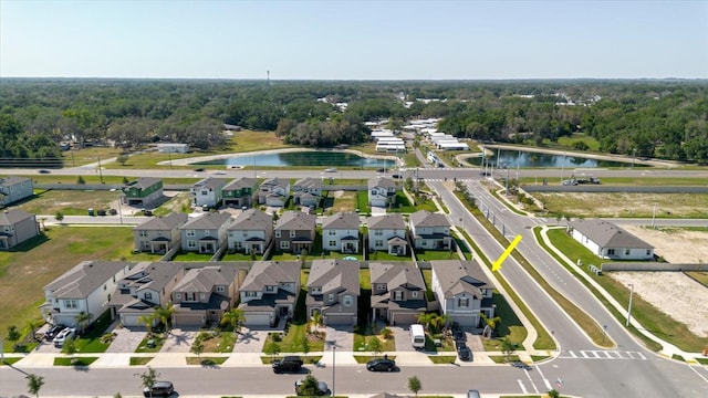 drone / aerial view featuring a water view and a residential view