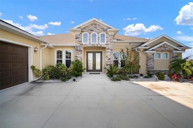 5325 San Remo Cir, Wimauma, FL 33598 - view of front of house with french doors, stone siding, and stucco siding