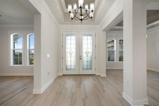5325 San Remo Cir, Wimauma, FL 33598 - entryway featuring light wood-style floors, french doors, a notable chandelier, and ornamental molding