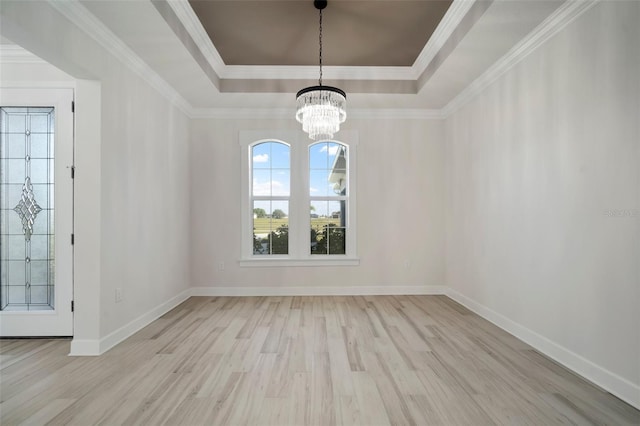 5325 San Remo Cir, Wimauma, FL 33598 - unfurnished dining area featuring crown molding, an inviting chandelier, wood finished floors, a raised ceiling, and baseboards