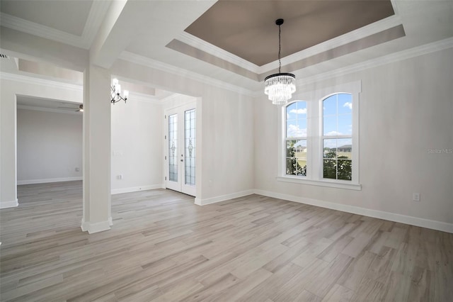 5325 San Remo Cir, Wimauma, FL 33598 - unfurnished dining area with crown molding, ceiling fan with notable chandelier, a tray ceiling, wood finished floors, and baseboards