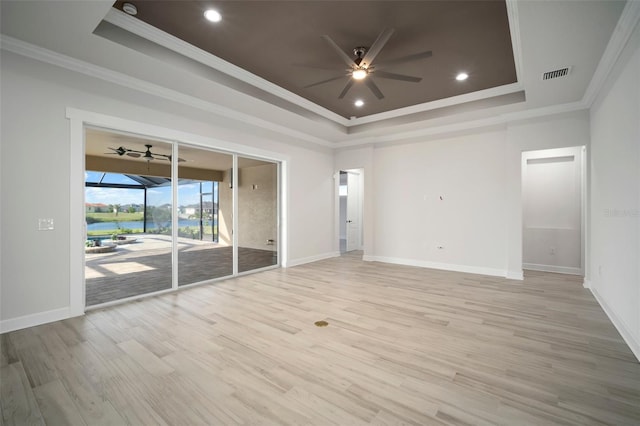 5325 San Remo Cir, Wimauma, FL 33598 - spare room with ornamental molding, ceiling fan, a raised ceiling, and light wood-type flooring