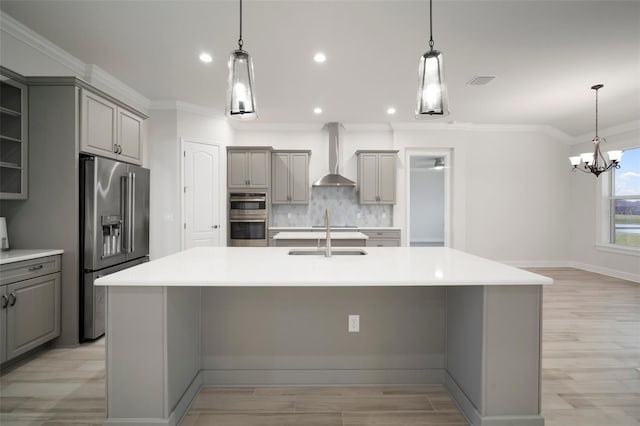 5325 San Remo Cir, Wimauma, FL 33598 - kitchen with wall chimney range hood, gray cabinetry, stainless steel appliances, a large island with sink, and a sink