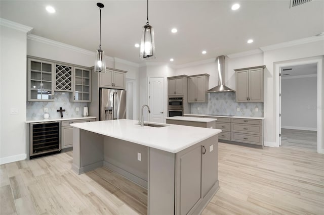 5325 San Remo Cir, Wimauma, FL 33598 - kitchen with wine cooler, appliances with stainless steel finishes, gray cabinetry, and wall chimney exhaust hood