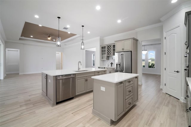 5325 San Remo Cir, Wimauma, FL 33598 - kitchen featuring an island with sink, gray cabinets, a sink, and appliances with stainless steel finishes