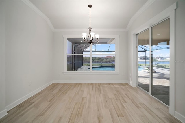 5325 San Remo Cir, Wimauma, FL 33598 - unfurnished dining area with a chandelier, light wood-style flooring, crown molding, and a healthy amount of sunlight