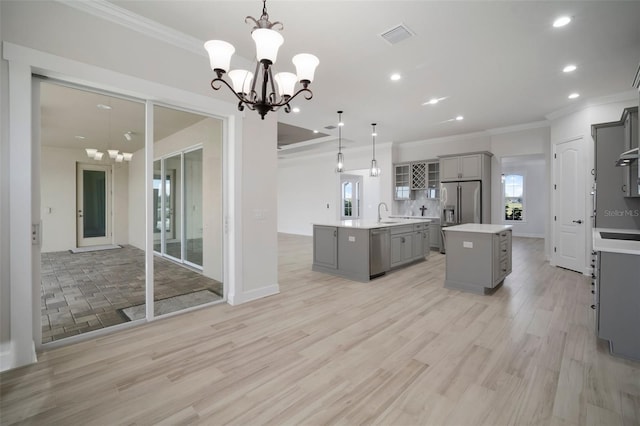 5325 San Remo Cir, Wimauma, FL 33598 - kitchen featuring a center island with sink, gray cabinetry, a notable chandelier, and stainless steel appliances