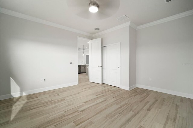 5325 San Remo Cir, Wimauma, FL 33598 - unfurnished bedroom featuring a closet, baseboards, crown molding, light wood-style floors, and visible vents