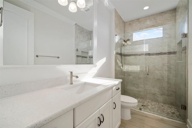 5325 San Remo Cir, Wimauma, FL 33598 - full bath featuring vanity, visible vents, toilet, wood finished floors, and a stall shower