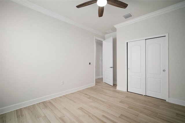 5325 San Remo Cir, Wimauma, FL 33598 - unfurnished bedroom with visible vents, baseboards, a closet, crown molding, and light wood finished floors