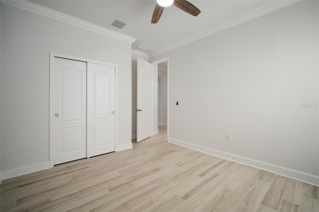 5325 San Remo Cir, Wimauma, FL 33598 - unfurnished bedroom featuring a closet, baseboards, crown molding, visible vents, and light wood finished floors