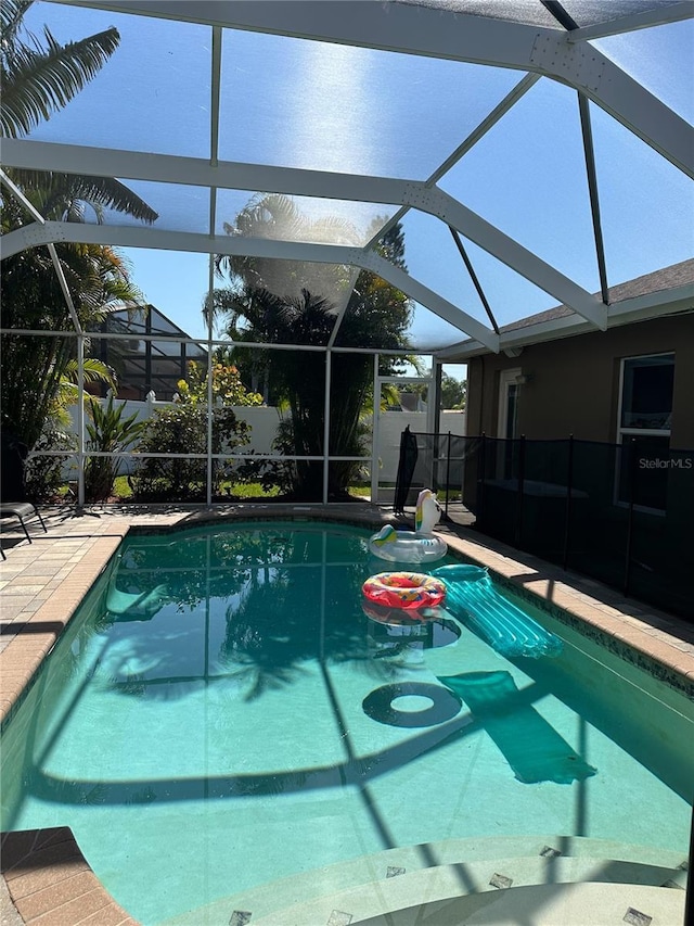 view of pool featuring a fenced in pool, fence, a lanai, and a patio