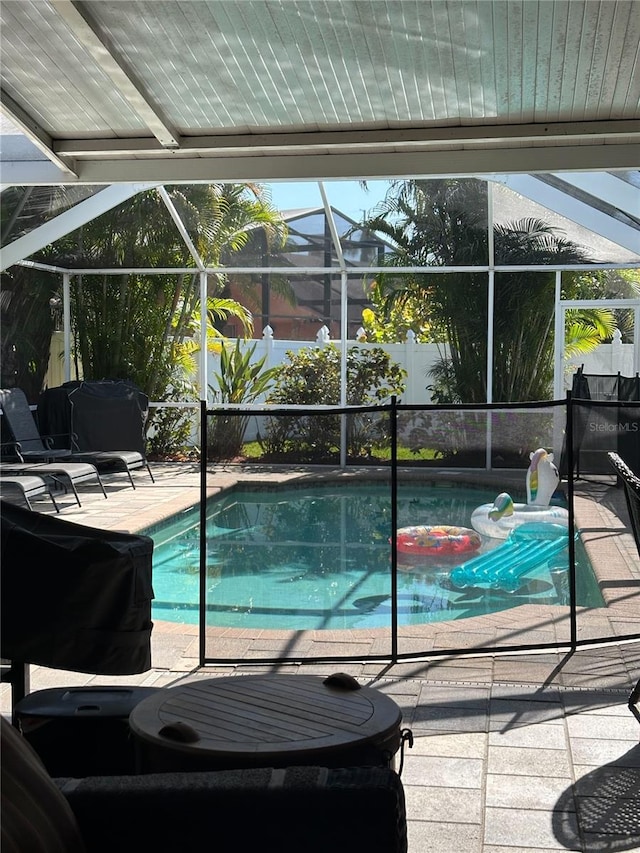 view of pool with a fenced in pool, a patio area, and a lanai