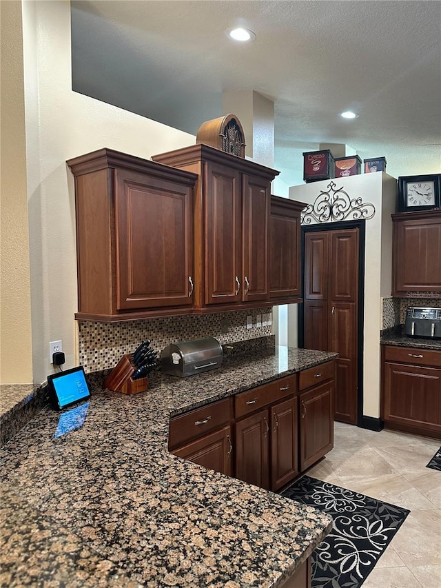kitchen featuring dark brown cabinets, recessed lighting, and decorative backsplash