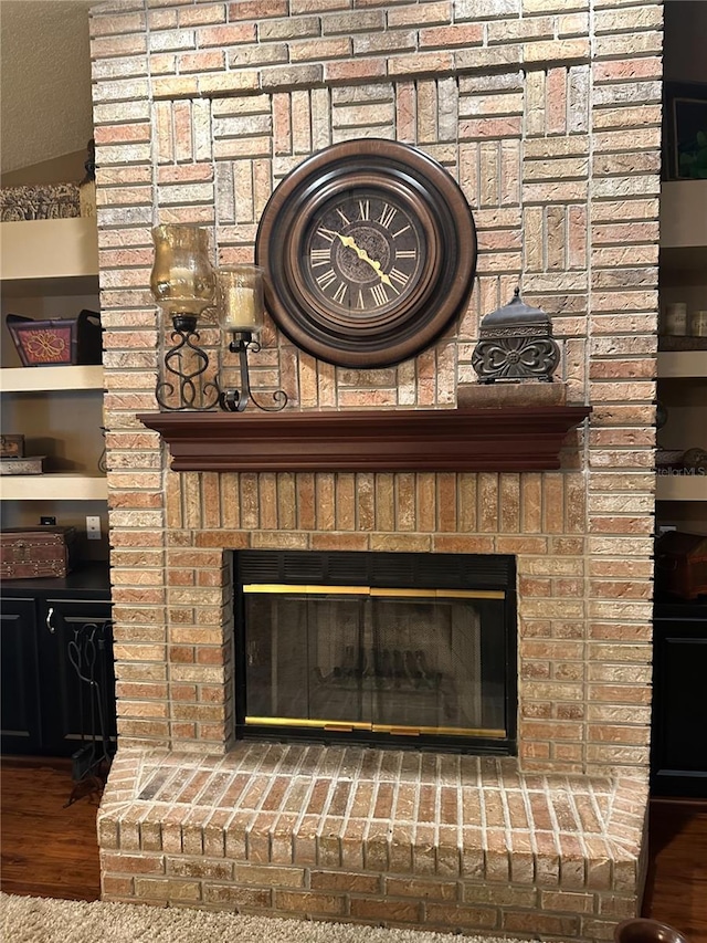 room details with wood finished floors and a fireplace