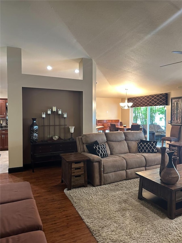 living room with an inviting chandelier and wood finished floors