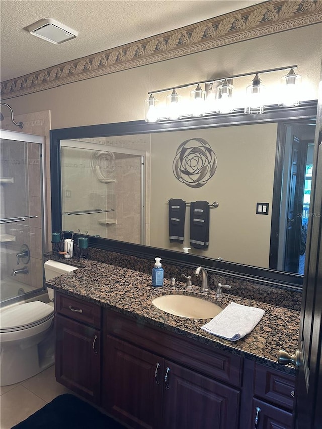 full bath featuring vanity, tile patterned flooring, toilet, shower / tub combination, and a textured ceiling