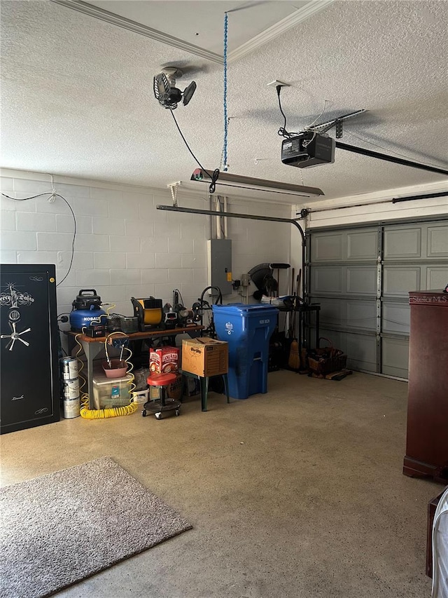 garage with concrete block wall, a garage door opener, and electric panel