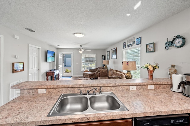 6745 Basswood Cir, Zephyrhills, FL 33542 - kitchen featuring open floor plan, light countertops, visible vents, dishwasher, and a sink