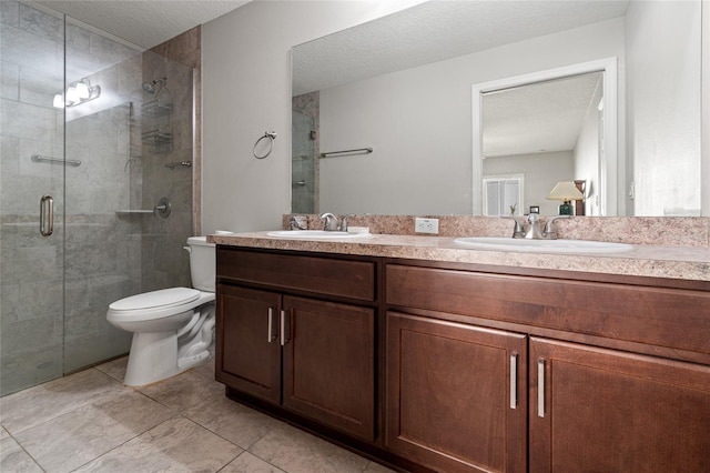 6745 Basswood Cir, Zephyrhills, FL 33542 - bathroom featuring a shower stall, a textured ceiling, double vanity, and a sink