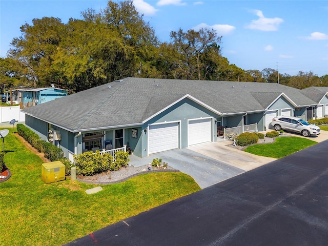 6745 Basswood Cir, Zephyrhills, FL 33542 - single story home with aphalt driveway, covered porch, roof with shingles, a front lawn, and an attached garage
