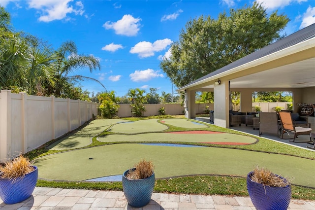 4769 Stoneview Cir, Oldsmar, FL 34677 - fenced backyard with a putting green and a patio area
