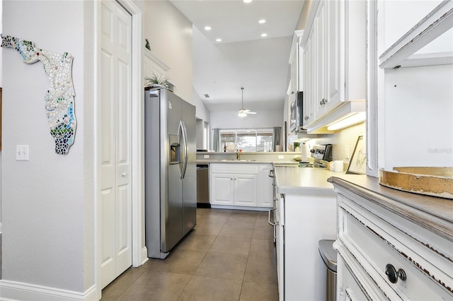 kitchen featuring light countertops, appliances with stainless steel finishes, a ceiling fan, white cabinetry, and recessed lighting