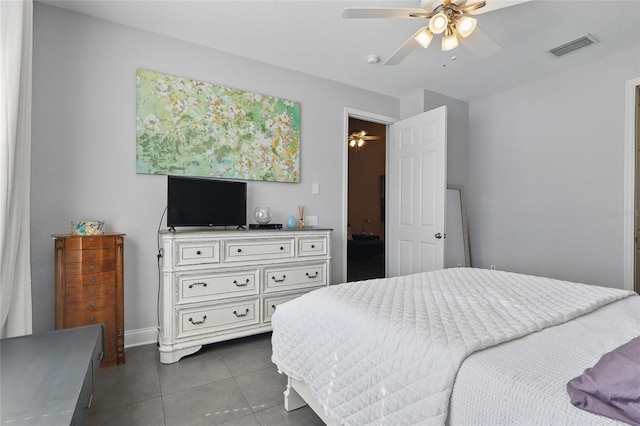 bedroom with visible vents, dark tile patterned floors, ceiling fan, and baseboards