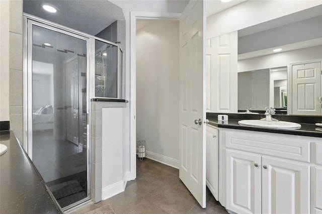 bathroom featuring a shower stall, recessed lighting, vanity, and baseboards