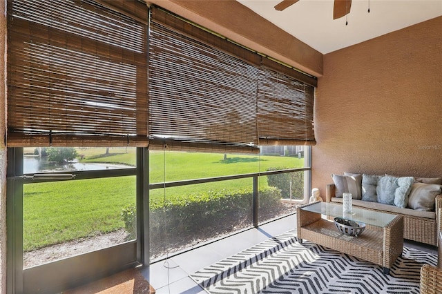 sunroom / solarium featuring ceiling fan