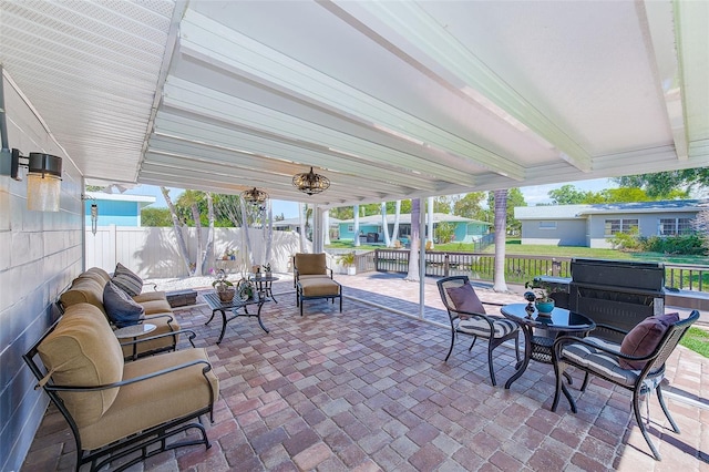 view of patio / terrace featuring grilling area, an outdoor hangout area, and fence